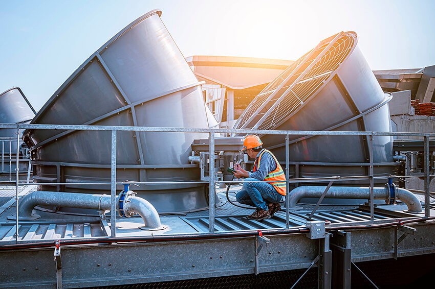 Man checking industrial blower maintenance